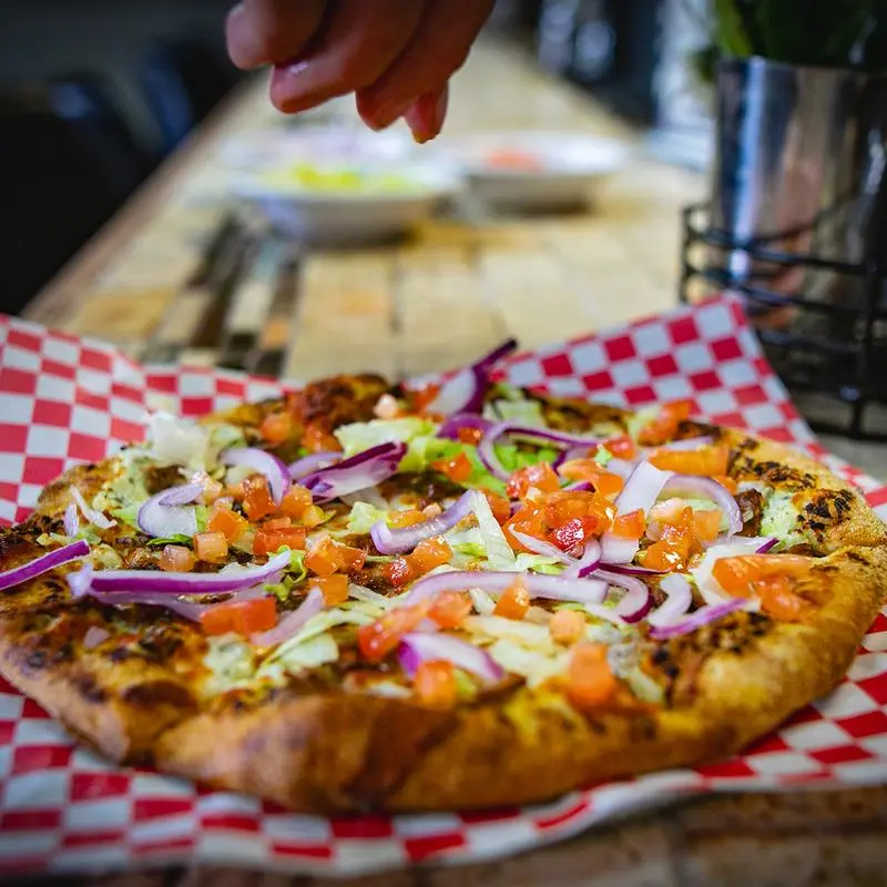 A Ben and Jay's pizza ready at the table